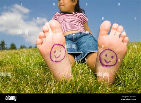 Young Girl With Smiley Faces On Bare Feet Stock Photo Alamy