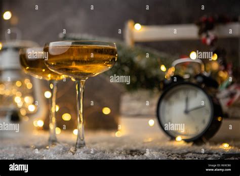 Picture Of Two Wine Glasses On Blurred Background With Christmas Tree Lantern Clock Stock