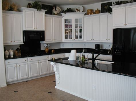 An inky surface also works in a more traditional kitchen; The Popularity of the White Kitchen Cabinets - Amaza Design