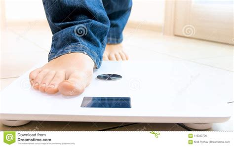 Barefoot Girl Stepping On Young Man Stock Image