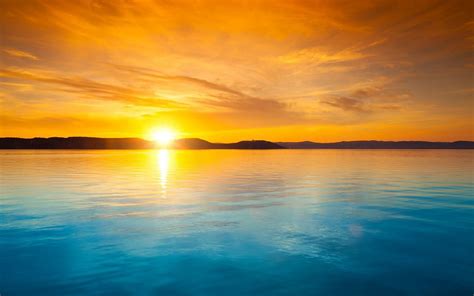Orange Sky Over The Blue Water At Sunset Free Desktop