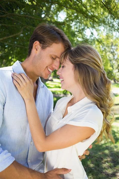 Cute Couple Hugging In The Park And Smiling At Each Other Stock Image Image Of Sunshine