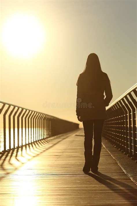 Sad Woman Silhouette Walking Alone At Sunset Stock Photo Image Of