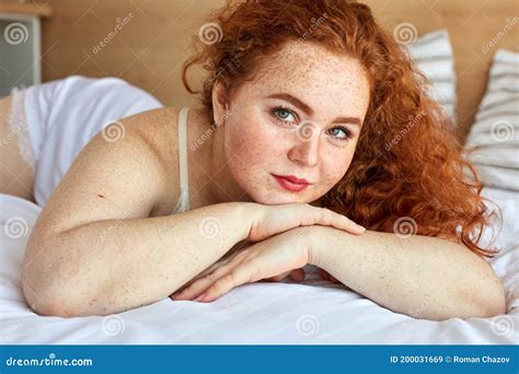 Mujer Gorda De Cabello Rojo En Lencería Mentiras En La Cama Descansar Imagen de archivo Imagen