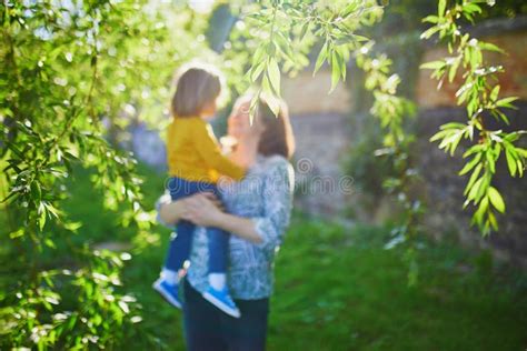 Happy Young Mother Holding Her Adorable Toddler Daughter Stock Image