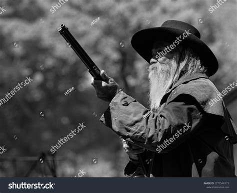 Senior Cowboy Standing Gun Guard Safety Stock Photo