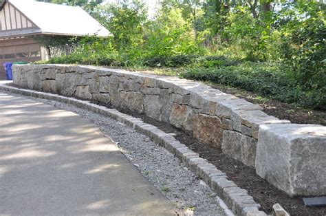 Curvature And Character In This Reclaimed Granite Block Retaining Wall