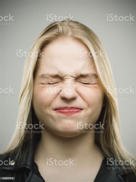 Angry Young Woman Clenching Eyes Stock Photo Download Image Now