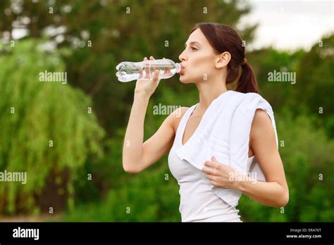Pretty Girl Drinking Water In Park Stock Photo Alamy
