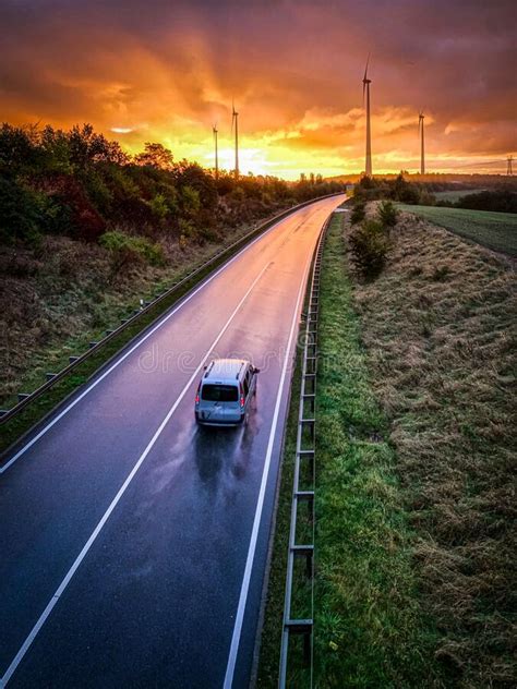 Car Is Driving On A Wet Road Towards Sunrise Stock Image Image Of