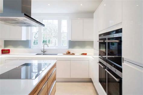 Walnut & gloss white kitchen. Gloss contemporary kitchen with centrepiece walnut island ...