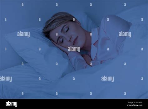 Beautiful Mature Woman Sleeping Well On Pillow In The Night Stock Photo