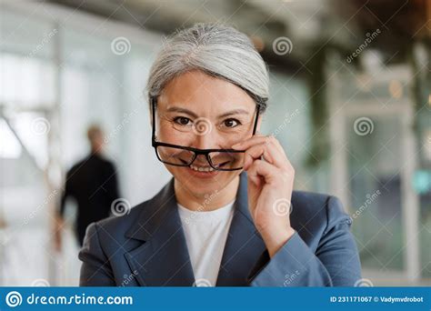 happy white haired mature businesswoman in eyeglasses smiling at camera stock image image of