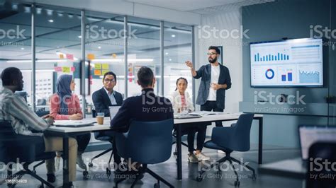 Diverse Modern Office Businessman Leads Business Meeting With Managers