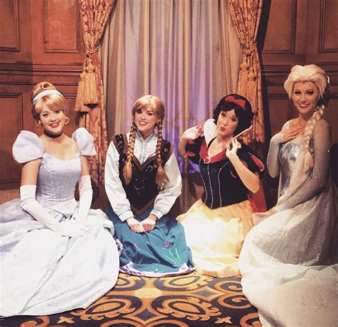 Four Women Dressed As Princesses Posing For A Photo