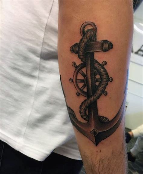 A compass tattoo is a common sight among fishermen and sailors. 3D like big black and white anchor with steering wheel ...