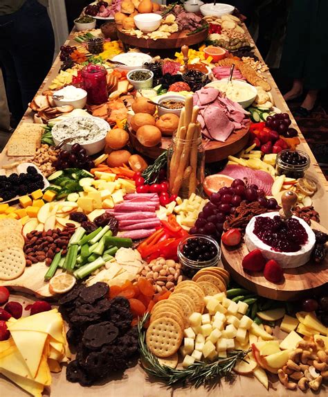 a long table covered with lots of different types of food and snacks on top of it