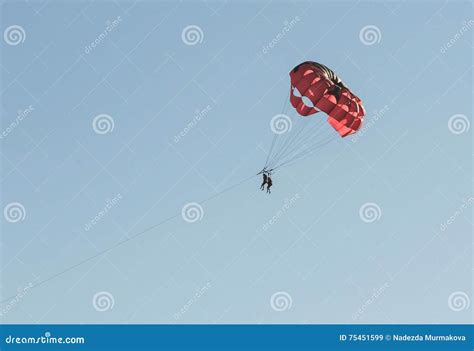 Parasailing On A Red Parachute Over Water Stock Image Image Of