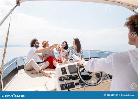 Happy Friends Clinking Glasses Of Champagne And Sailing On Yacht Stock