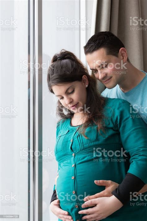 Expectant Parents Holding Growing Baby Bump Stock Photo Download