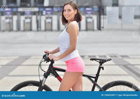 Portrait Of Pretty Young Girl With Bicycle In A The City Stock Image