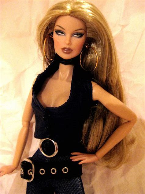 A Barbie Doll With Blonde Hair Wearing Black Clothes And Gold Hoop