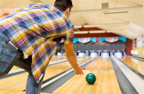 Close Up Of Man Throwing Ball In Bowling Club