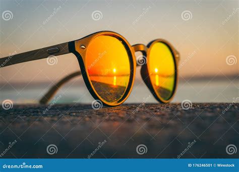 Pair Of Sunglasses On The Beach With The Reflection Of The Sunset Stock Image Image Of