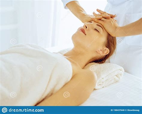 Beautiful Woman Enjoying Facial Massage With Closed Eyes In Spa Center Relax Treatment Concept