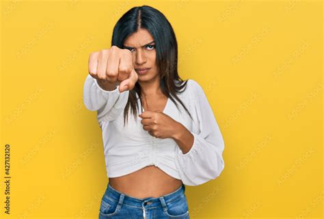 Young Latin Transsexual Transgender Woman Wearing Casual Clothes Punching Fist To Fight