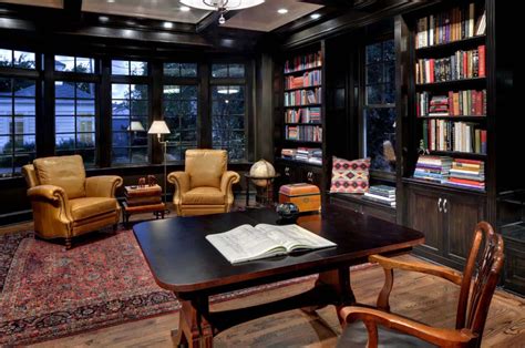 The Library Has Many Books On It And Leather Chairs In Front Of Large