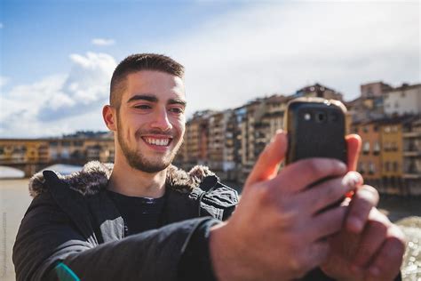 Young Man Taking A Selfie With A Mobile Phone In Florence By Stocksy Contributor Giorgio