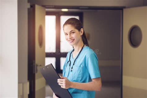 A Beautiful Young Woman Doctor Or Nurse Is Standing In A Hospital