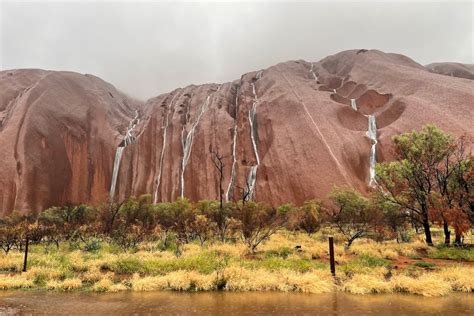 Waterfalls Cascade Down Uluru As Severe Weather Brings Heavy Rain To Nt