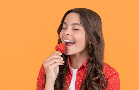 Premium Photo Happy Teen Girl Eat Strawberry On Yellow Background