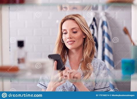 The inclusion of a wash basin is common. View Through Bathroom Cabinet Of Young Woman Wearing ...