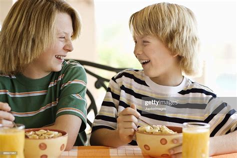 Boys Eating Cereal At Table High Res Stock Photo Getty Images
