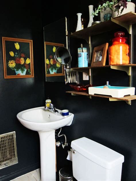 I am a fan of a more primitive/rustic look so we painted our cabinets black, rubbed the corners with sand paper and your bathroom is great. black bathroom eclectic-bathroom
