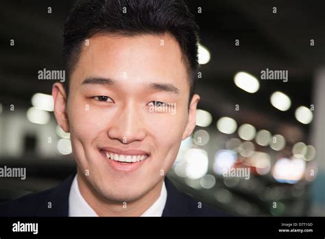 Traveler smiling in airport parking lot Stock Photo - Alamy
