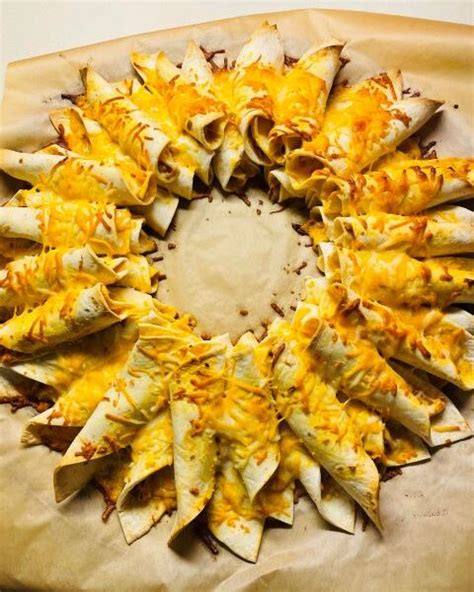 Using tortilla shells that are cut in half, filled with chicken and cheese, and rolled up, then, placed in a giant ring. Blooming Chicken Quesadilla Ring | Olive Oil Marketplace