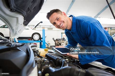 Mechanic Using Tablet On Car Stock Photo Download Image Now