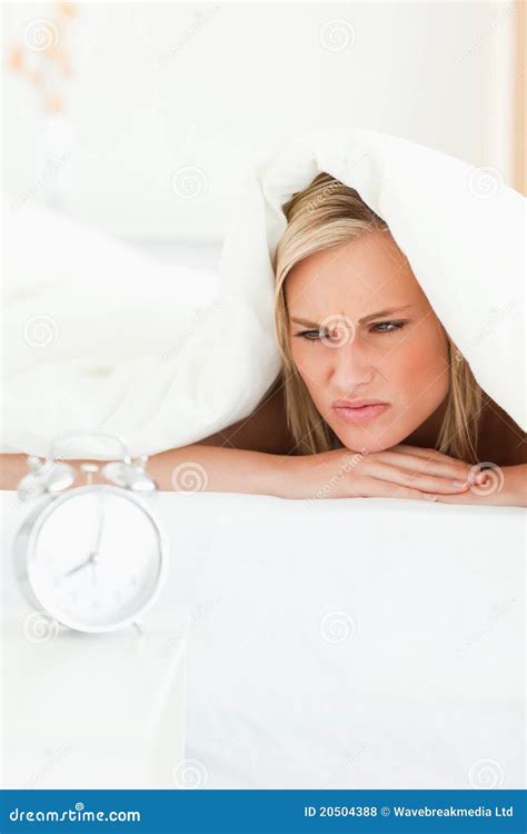 Portrait Of A Disgruntled Woman Waking Up Stock Photo Image Of Alarm