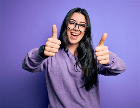 Young Brunette Woman Wearing Glasses Over Purple Isolated Backgr