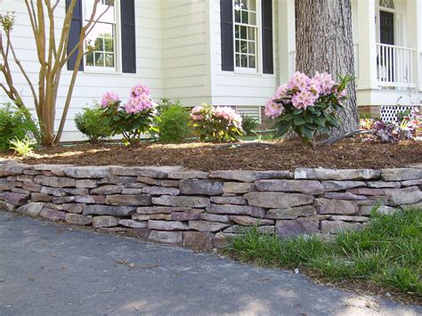 This Little Stacked Stone Wall Is Being Used To Prevent Mulch From