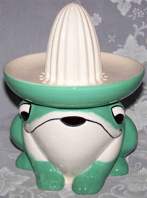 A Ceramic Frog With A Hat On Its Head