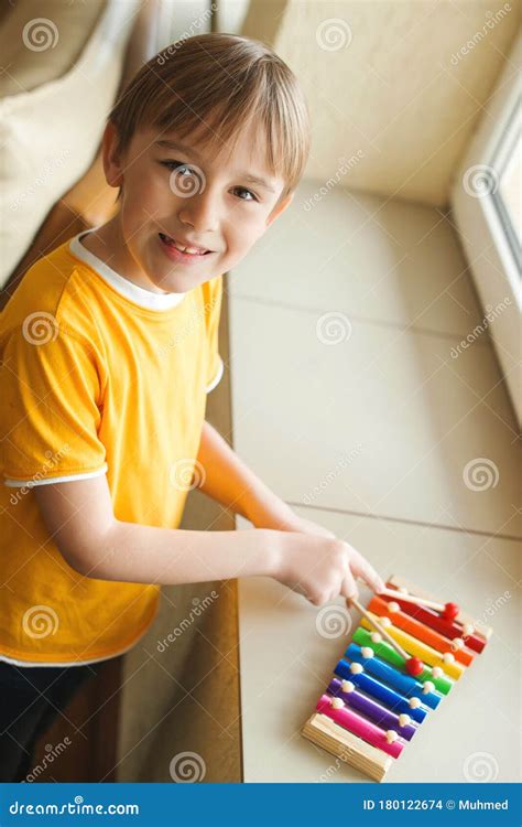 Cute Boy Playing With Xylophone At Home Musical Education And