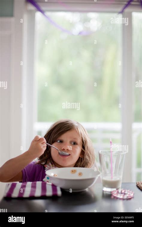 A Little Girl Eating Breakfast Stock Photo Alamy