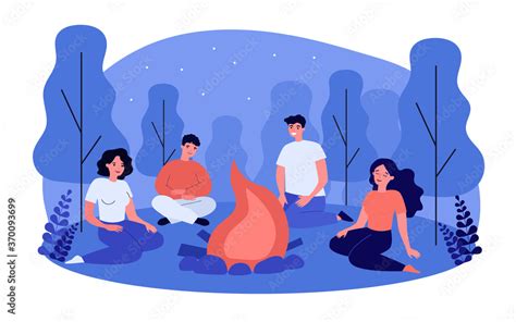 Happy People Sitting At Campfire At Night Group Of Friends Gathering Around Fire In Woods And