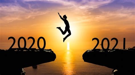 Premium Photo Silhouette Man Jump Between 2020 And 2021 Years With