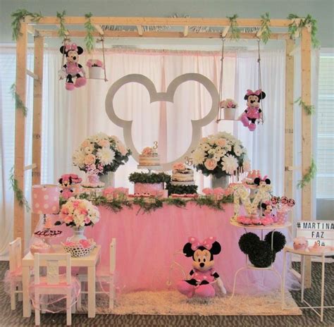 A Minnie Mouse Themed Birthday Party With Pink And White Decorations